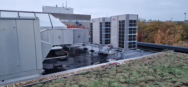 Buitenunits en luchtbehandelingskasten op een groen dak