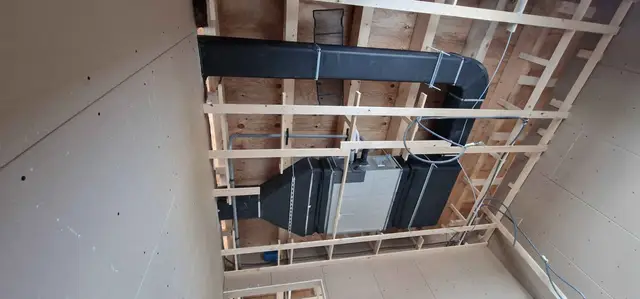 Luchtkanaal en ventilatie-unit in een plafond in aanbouw